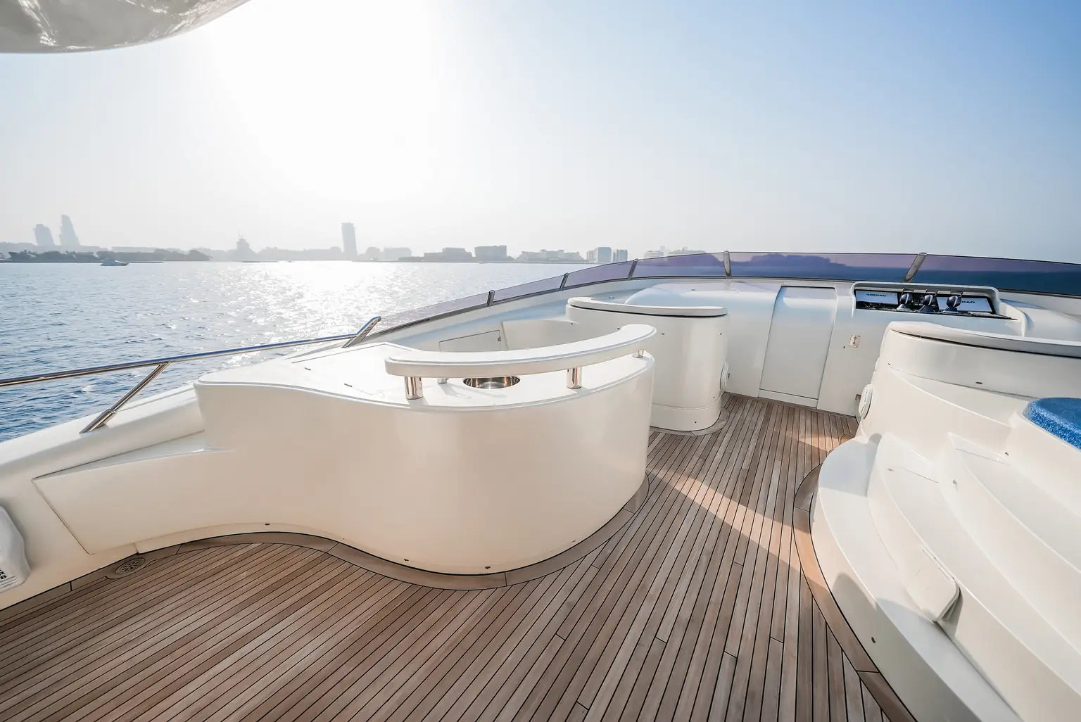 Curved upper deck seating and teak decking in full sun