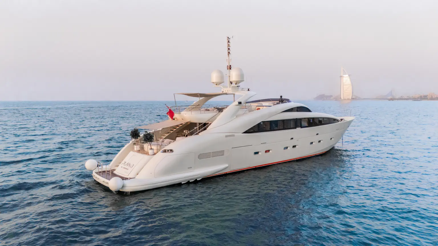 Three quarter bow view of Plan B of Freedom at anchor on flat water