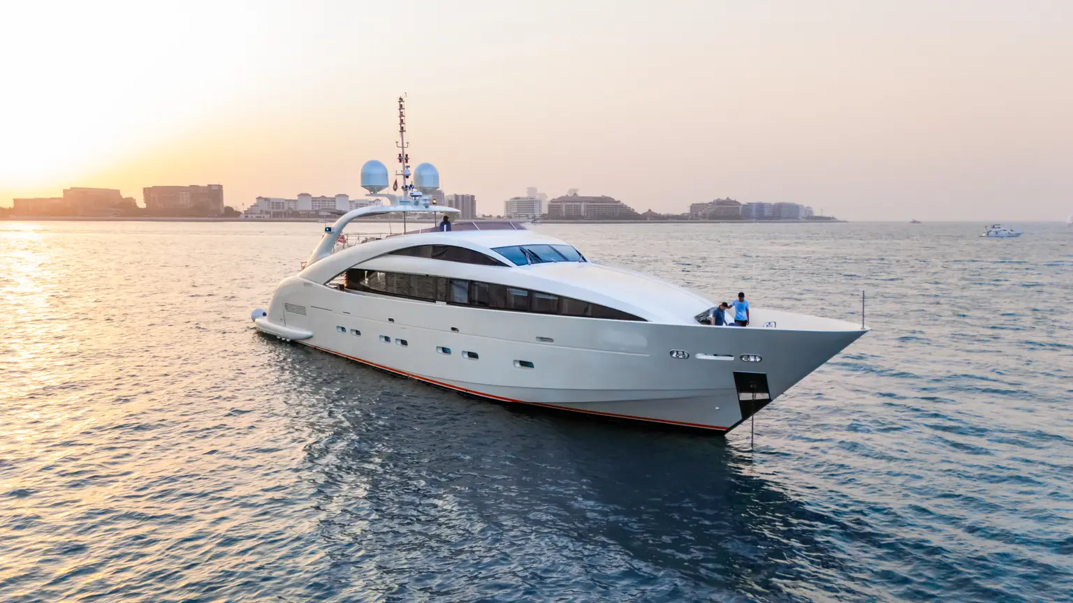 Plan B of Freedom at anchor off Dubai in low golden evening light