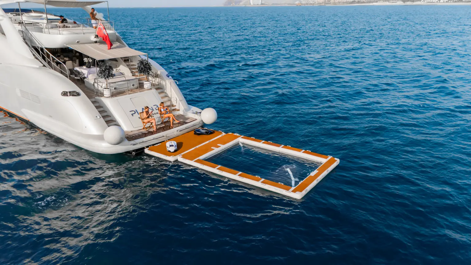 Aerial view across the stern of Plan B of Freedom with the bathing platform and sea pool deployed