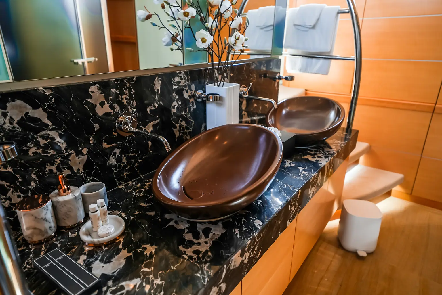 Guest bathroom with twin basins set into dark marble