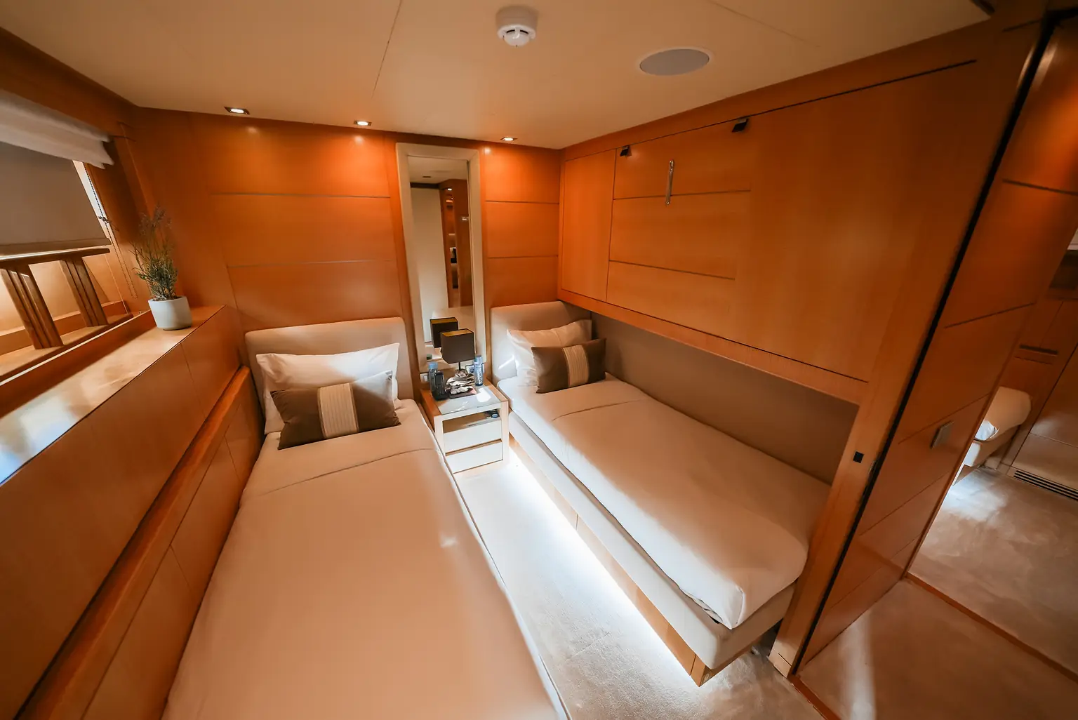 Twin cabin with two single beds and fitted cherry joinery